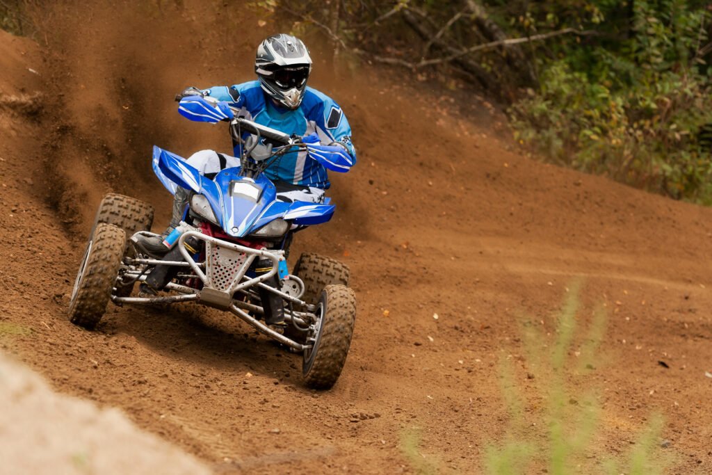 blue and white ATV Wraps on atv driving on track.
