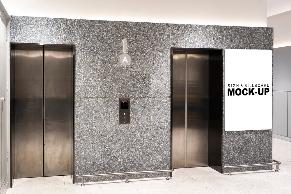 white and black backlit signage beside elevator.